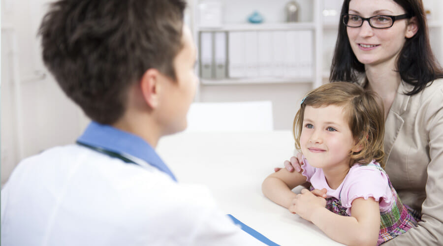 A child with her mother at an eye appointment