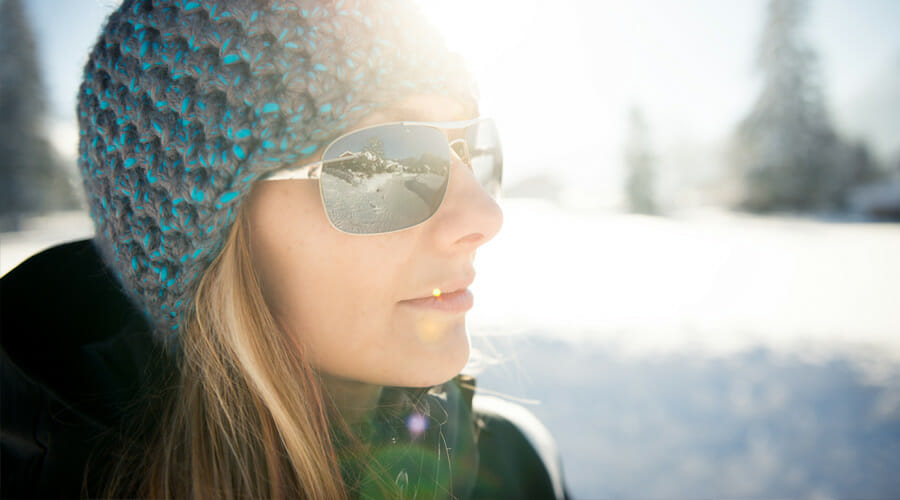 A woman wearing sunglasses on a snowy mountain