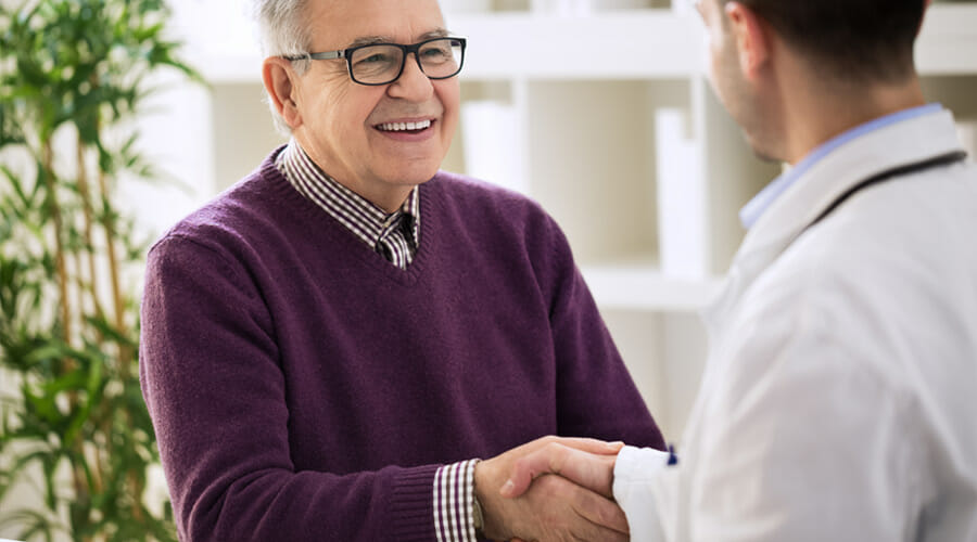 a man shaking hands with a doctor