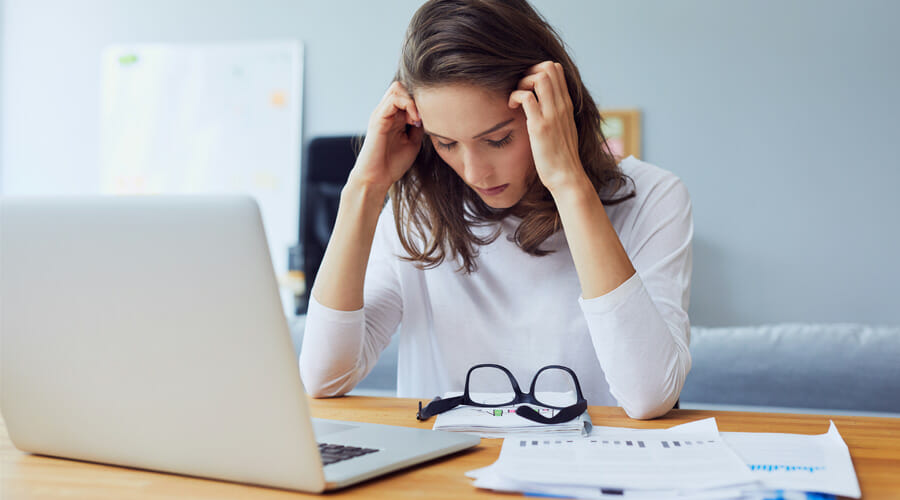 A woman holding her head in pain