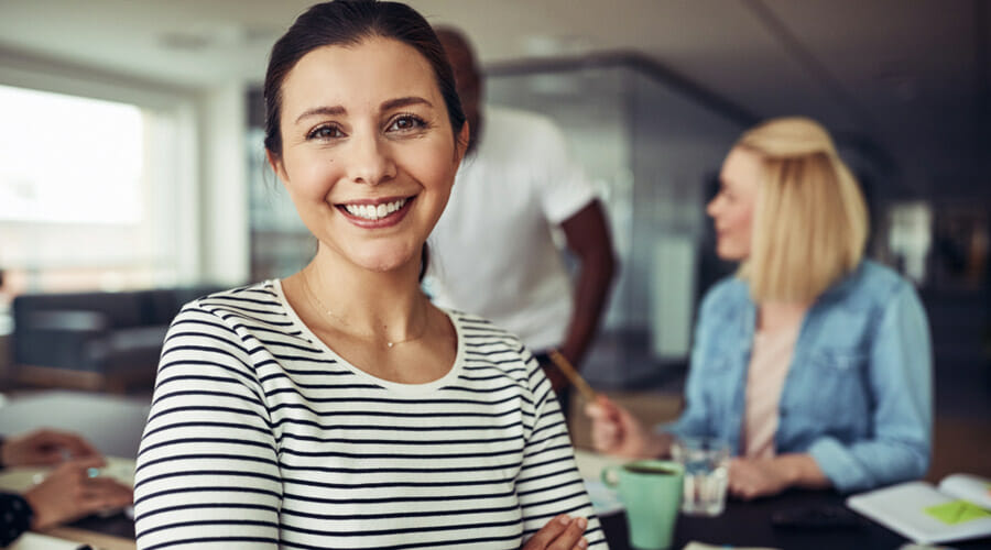 a woman smiling at a coffee shop