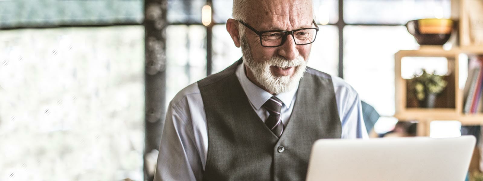 Elder gentleman staring at a laptop screen