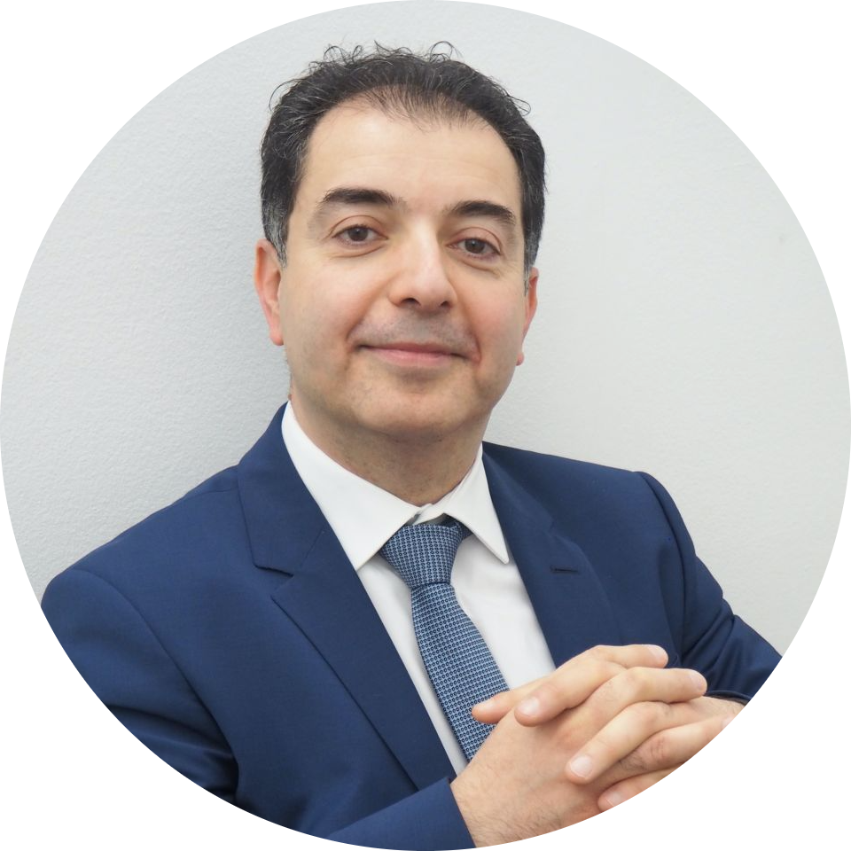 A portrait image of Mr Samer Hamada wearing a suit and smiling