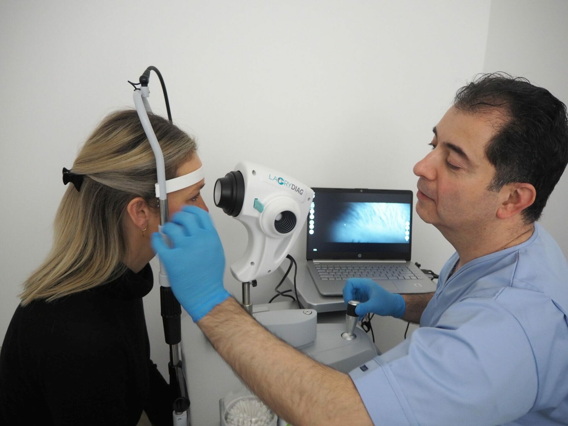 Mr Samer Hamada using an ocular surface analyzer to help diagnose a patient's dry eye disease.