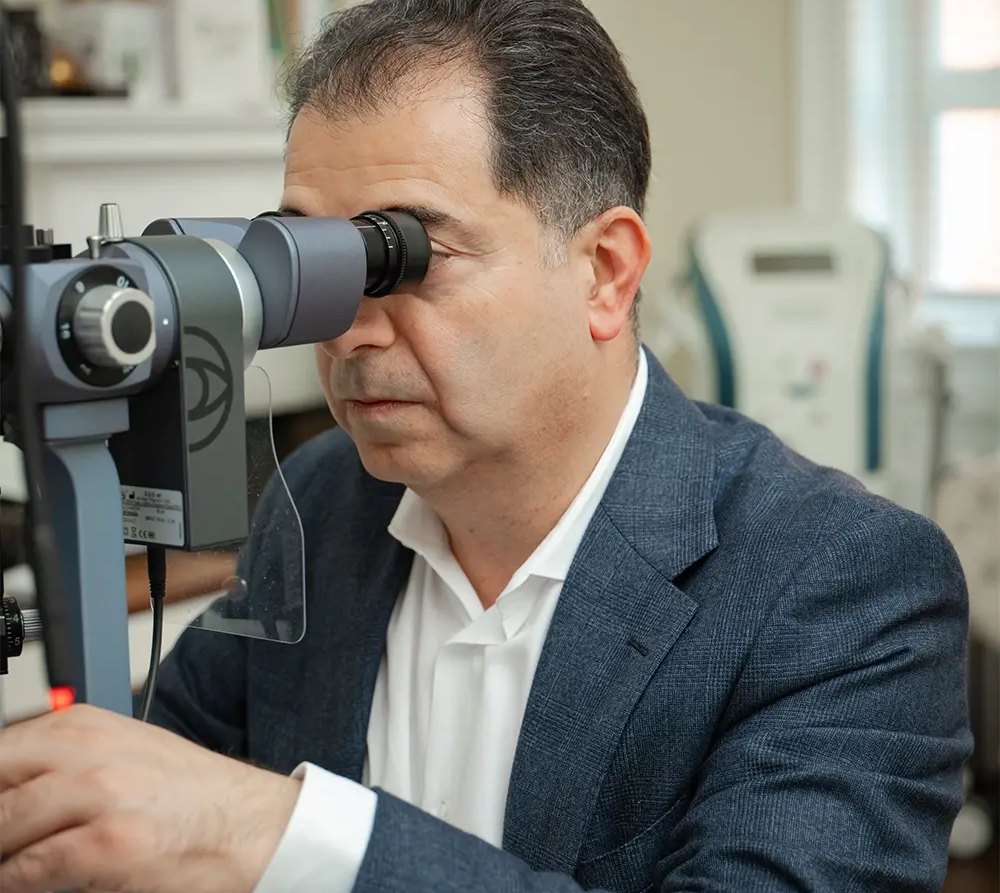 Mr Samer Hamada at the operating microscope