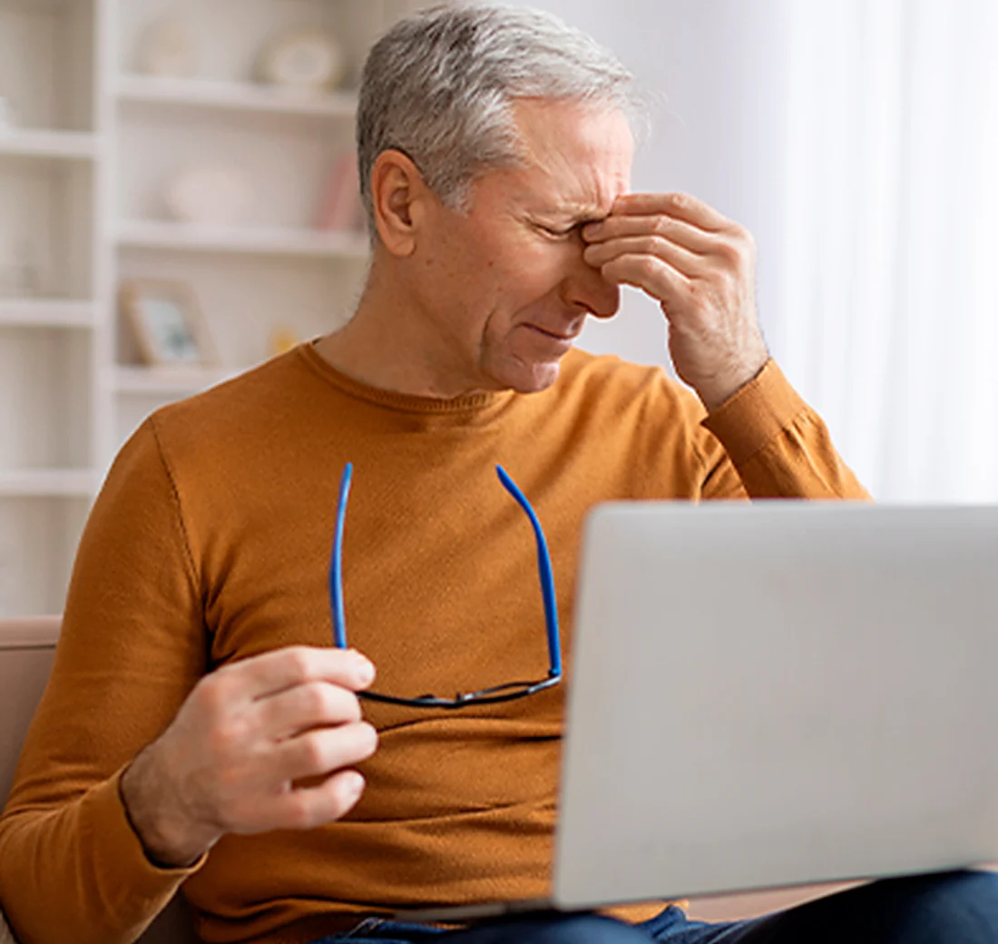 Man with an irritated eyelid at home